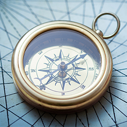 Compass lying on map