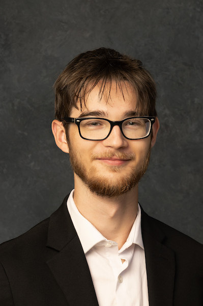 man with short blonde hair and dark glasses on