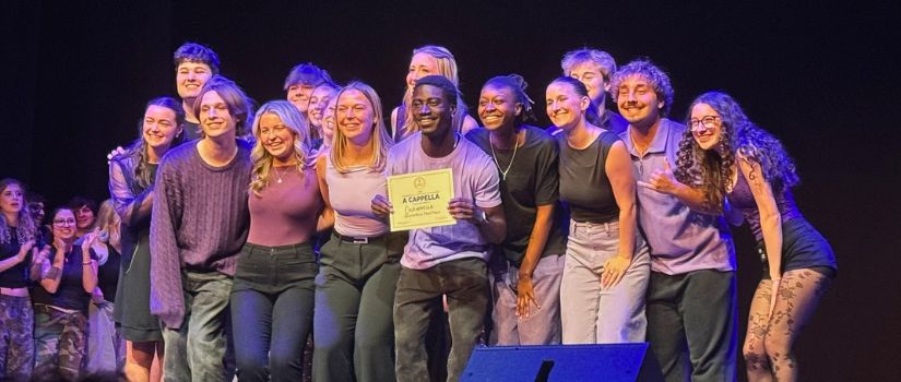 Group of a cappella students pose for a photo