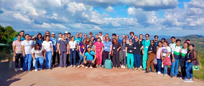Group photo in front of mountain landscape