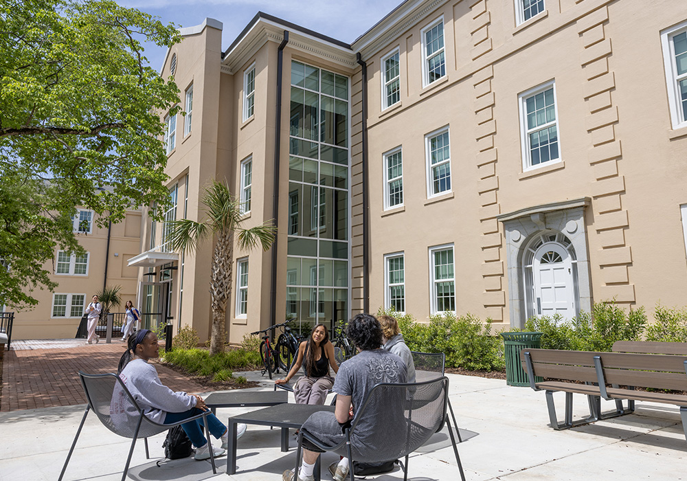 students sitting in a courtyard on campus