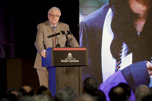 man speaks at a podium