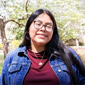 Michelle Ayala-Perez smiles while outside on USC's historic Horseshoe